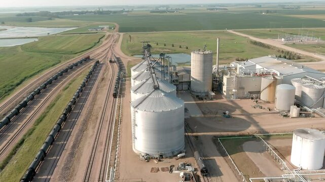 Aerial flyover a factory producing ethanol and adjoining railroad yard in rural eastern South Dakota.