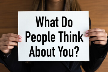 What do people think about you? Woman with white page, black letters. Character, personality, feedback.