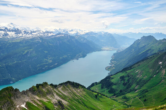 Serene view of Lake Brienz, Switzerland, surrounded by majestic mountains, lush greenery, and stunning alpine scenery. A perfect representation of nature's beauty.