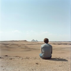Fototapeta premium Lone Traveler Contemplates Ancient Pyramids in Desert, Journey of Discovery, Solitude and Exploration