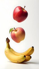 Fresh apples and bananas are artistically arranged in a creative floating display on a simple background