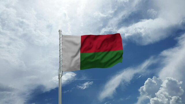 Madagascar Flag Waving Majestically on a Flagpole Against a Clear Blue Sky in Gentle Wind