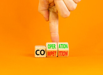 Competition or cooperation symbol. Concept word Competition or Cooperation on wooden cubes. Businessman hand. Beautiful orange background. Business Competition or cooperation concept. Copy space.