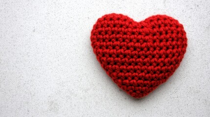 Obraz premium Handcrafted Red Crochet Heart on Light Background for Love Theme