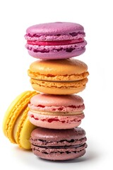 A tall pile of colorful macarons arranged in a rainbow fashion, featuring yellow, orange, green, blue, and red. Each macaron has its own distinct flavor and is a popular French dessert.