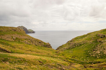 The majestic cliffs surrounded by blue waters. Vereda da Ponta de Sao Lourenco, Madeira, Portugal