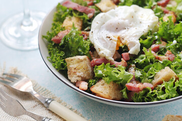 A bowl with salad lyonnaise served for lunch	