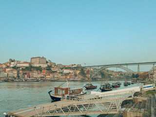 Naklejka premium Traditional Rabelo boats, once used to transport port wine along the Douro River, now symbolize Portugal s rich winemaking heritage.