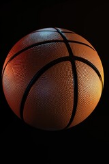 Fototapeta premium A textured basketball on a black background.