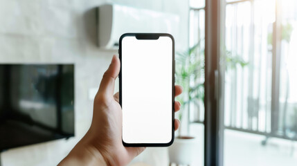 hand holding mobile phone with empty screen in front of air conditioning unit
