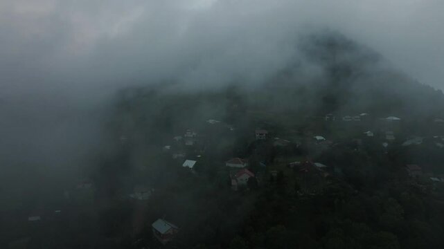 Aerial mystical view of clouds descending on a village between the mountains in Sakarya