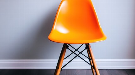 Orange Plastic Chair Against Gray Wall