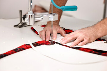 Man working at white table in professional workshop, closeup