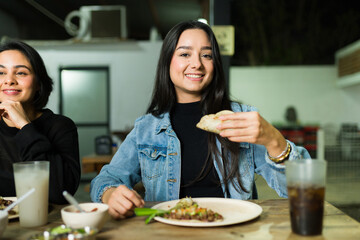 Happy friends savoring tacos and drinks at a lively taqueria, celebrating friendship and mexican flavors