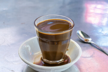 cup of coffee on a steel table in Phnom Penh