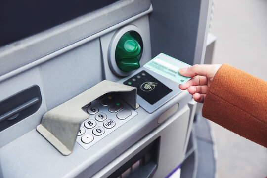 woman using a atm to pay the money