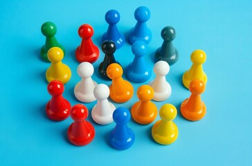 Colorful toy pawns arranged in an iconic formation on a blue background team concept