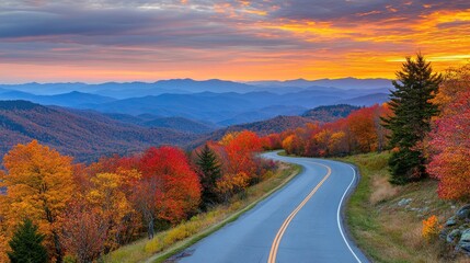 Fototapeta premium Scenic Autumn Road Winding Through Colorful Mountain Ranges
