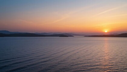 Obraz premium Serene Sunset Over Mountainous Seascape