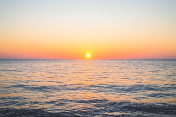 Obraz premium A serene sunset over calm waters, showcasing vibrant hues of orange and pink blending into the horizon, perfect for relaxation or meditation themes.