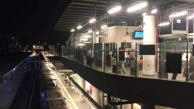 Train departure in Bakirkoy Marmaray Train Station at night in Istanbul, Turkey. (4K Video)