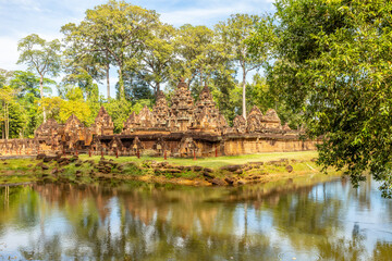 Hidden in jungles hindu Banteay Srei khmer sanctuary walls and towers surrounded by lake, Angkor Archaeological Park, Siem Reap, Cambodia
