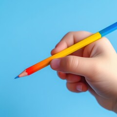 Child's hand holding colorful pencil.