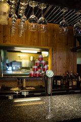 Half-lighted hall in a loft style restaurant open kitchen background.