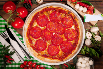 pepperoni pizza on wooden background. Top view of pepperoni pizza.