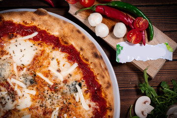 Pizza Quattro formaggi on wooden table