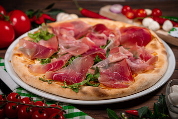 White pizza with prosciutto crudo, arugula and parmesan