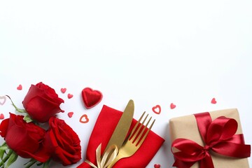 Valentine's Day concept. Top view photo with plate, cutlery, gift box, red rose and confetti on...