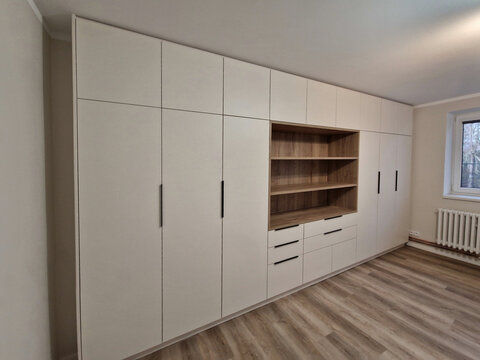 custom furniture production and customer wishes. laminate and chipboard. flooring made of wpc boards and vinyl. light beige tones. there are no cabinet doors yet, 