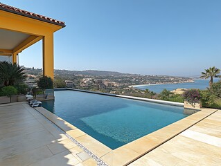 Fototapeta premium Infinity Pool Overlooking Coastal Town And Sea