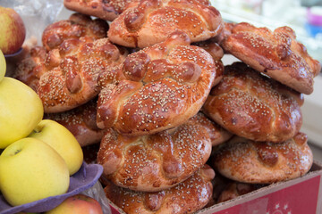 Authentic mexican day of the dead bread stacked at a street food market stall in Oaxaca City.
