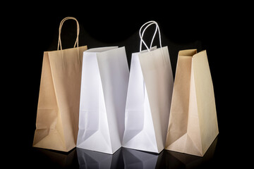Set of paper bags for shopping on black background. Mockup for design