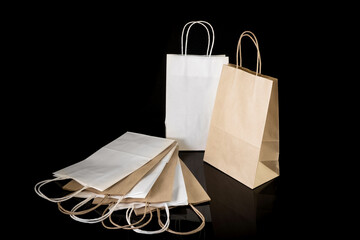 Set of paper bags for shopping on black background. Mockup for design