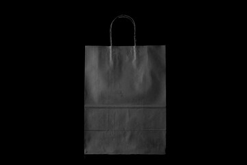 Recyclable craft paper bag for purchases, gifts and takeaway food mock up on black background. Environmentally friendly than single-use plastic bags