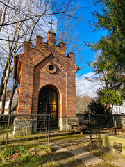 Historic brick chapel in a scenic countryside setting