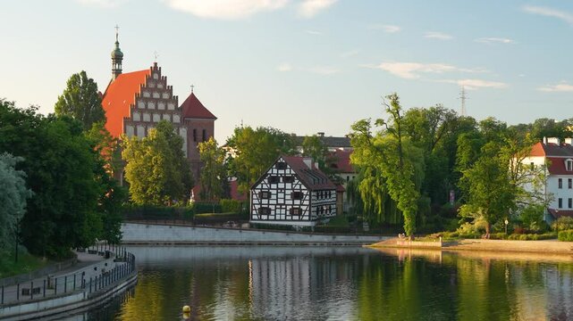 Bydgoszcz waterfront with the cathedral and the white granary on a warm spring morning.