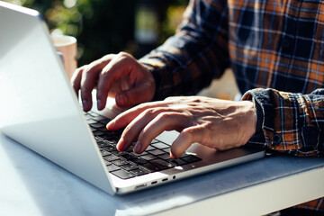 man hands near laptop close-up