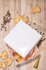 White box mockup between different sweets on the table and figures