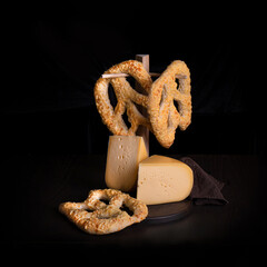Homemade baked pretzels with cheese on dark background