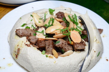 A food closeup shot of a popular Lebanese appetizer. Hummus or Chickpeas with meat, is considered one of the most popular dish in the Lebanese cuisine.