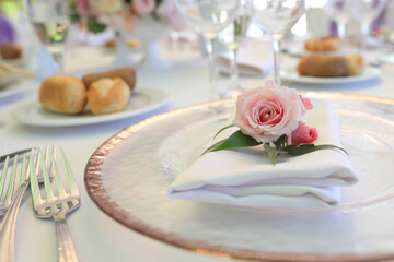 Beautiful table setting with tableware, flowers, accessories and beautiful rose for a party,...