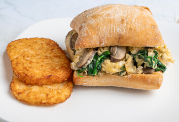 breakfast sandwich  served with  hash browns