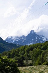 Beautiful landscape in the Alps. Mountain landscape with cloudy sky in summer in northern Italy. Mountain ranges and glaciers.