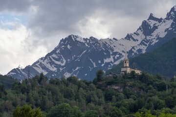 Beautiful landscape in the Alps. Mountain landscape with cloudy sky in summer in northern Italy. Mountain ranges and glaciers.