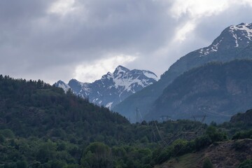 Beautiful landscape in the Alps. Mountain landscape with cloudy sky in summer in northern Italy. Mountain ranges and glaciers.
