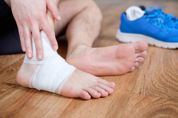 sportsman massaging his injured ankle